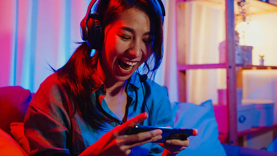 A mobile gamer testing cloud gaming experience on a smartphone